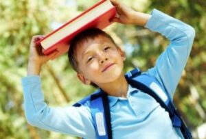 ребенок держит книжку над головой