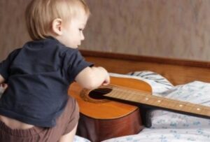 ребенок играет с гитарой
